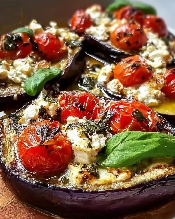 Baked eggplants with feta and cherry tomatoes on a plate.