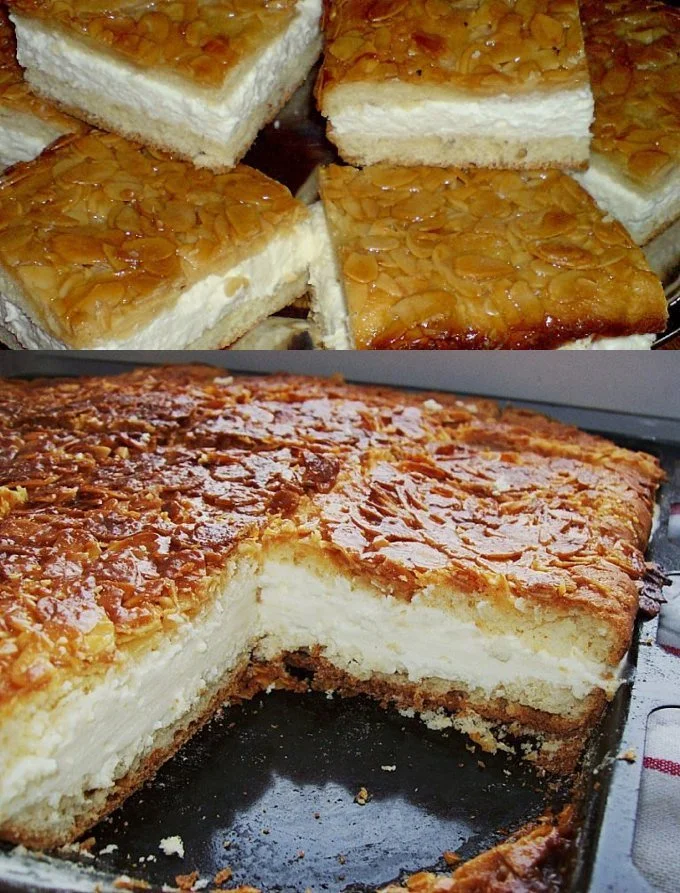 Ein köstlicher Bienenstich Kuchen mit Mandeln und Sahnefüllung auf einem rustikalen Tisch.